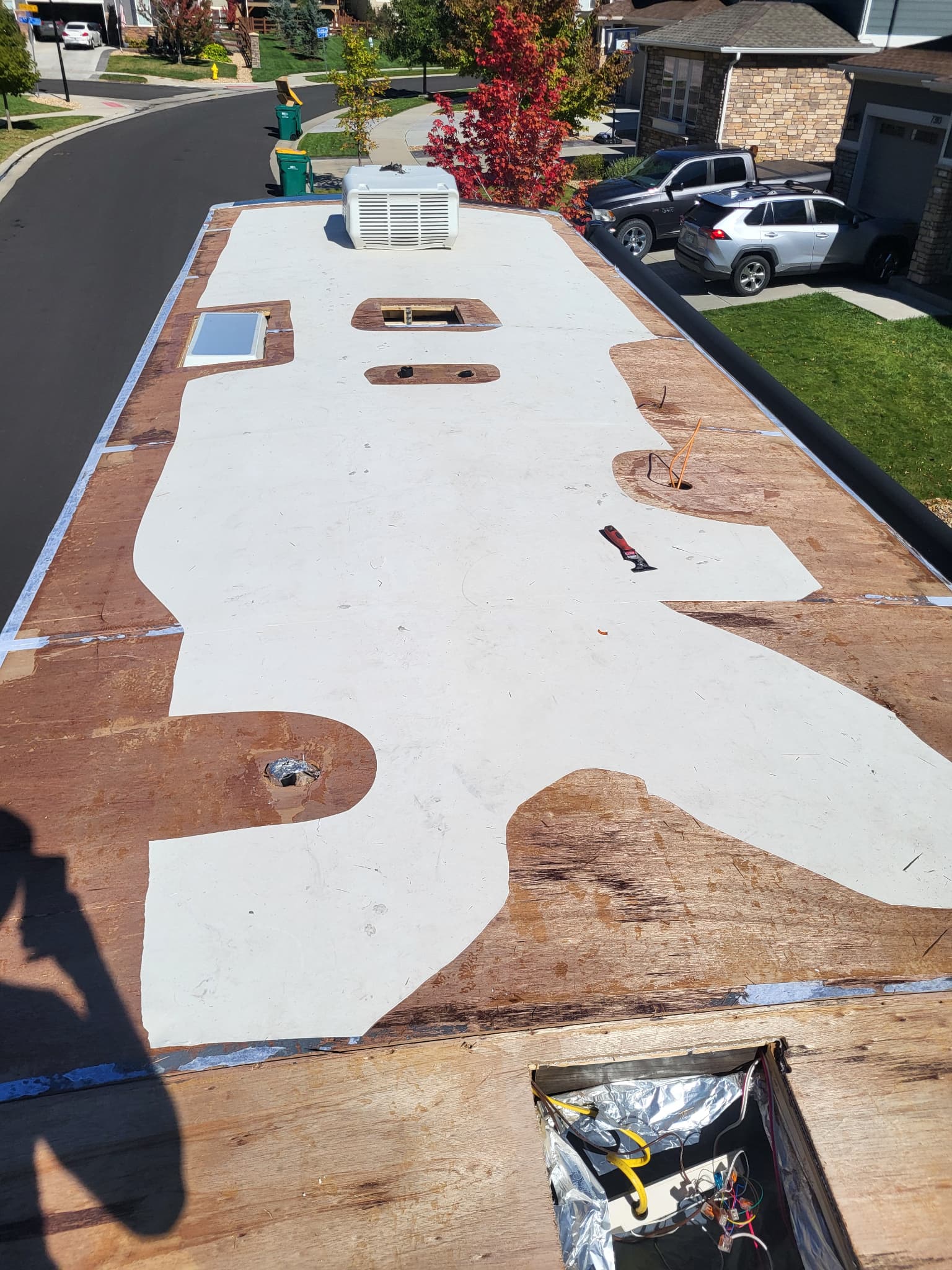 Removing old TPO membrane from RV roof during replacement process