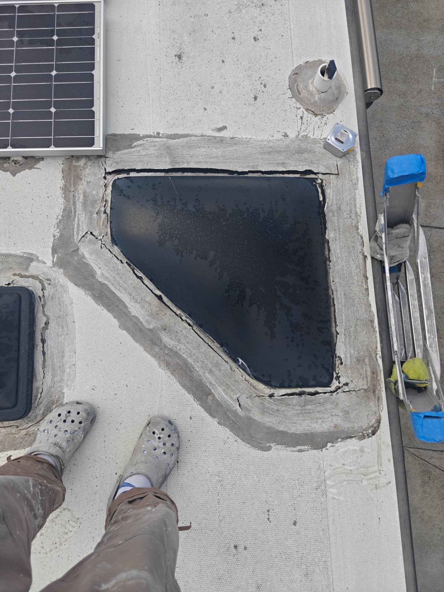 Cracked and failing sealant around skylight on RV roof before maintenance