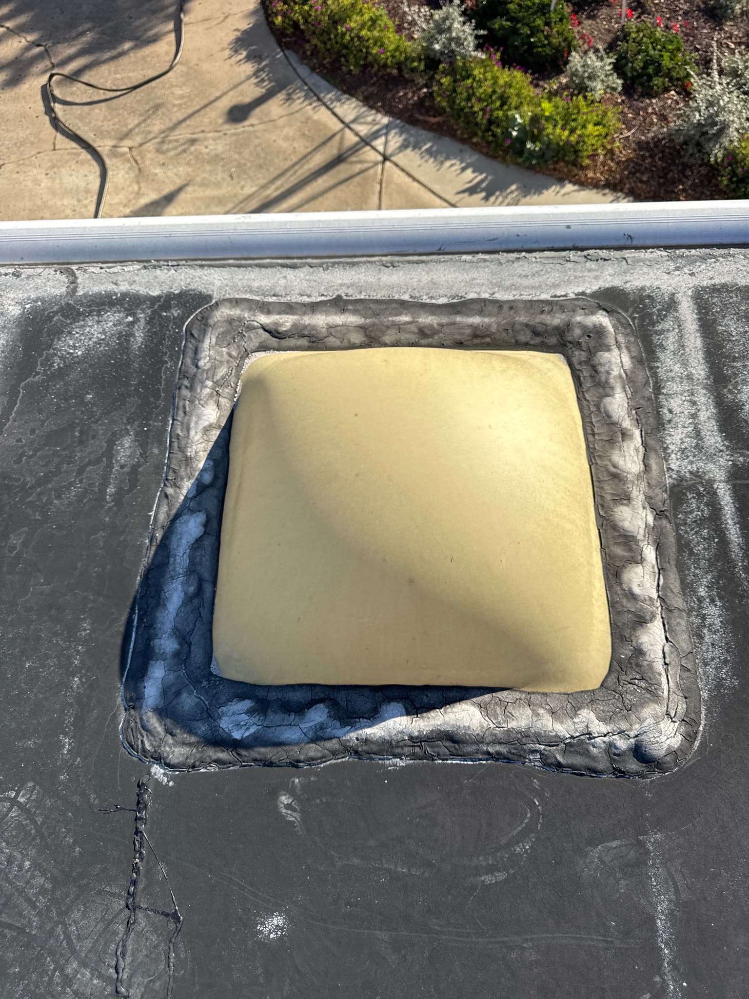 Cracked sealant around roof vent on RV before repair