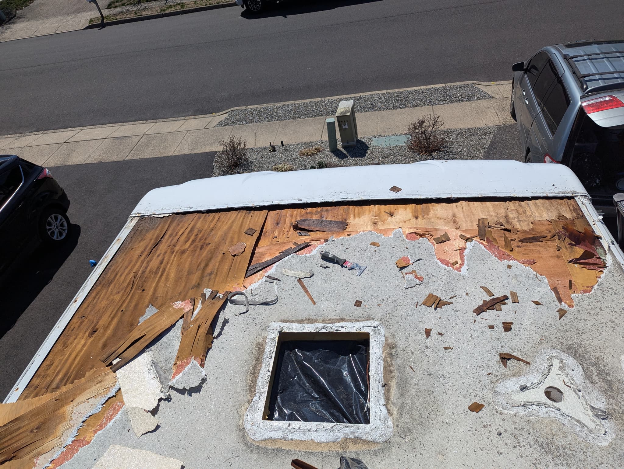Old TPO membrane lifted showing wet and damaged plywood underneath