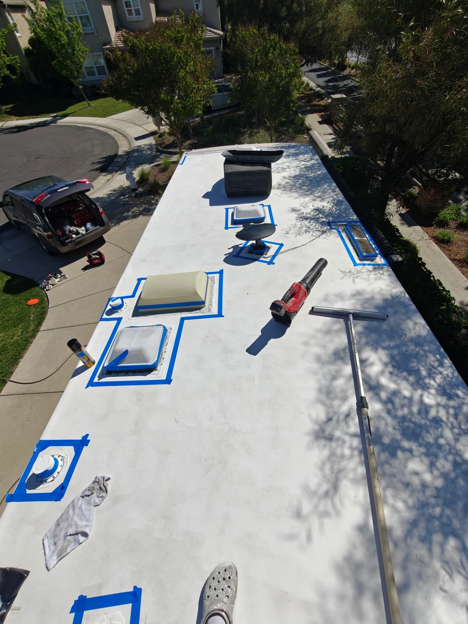 Prepared roof elements with masking tape before sealing on RV roof