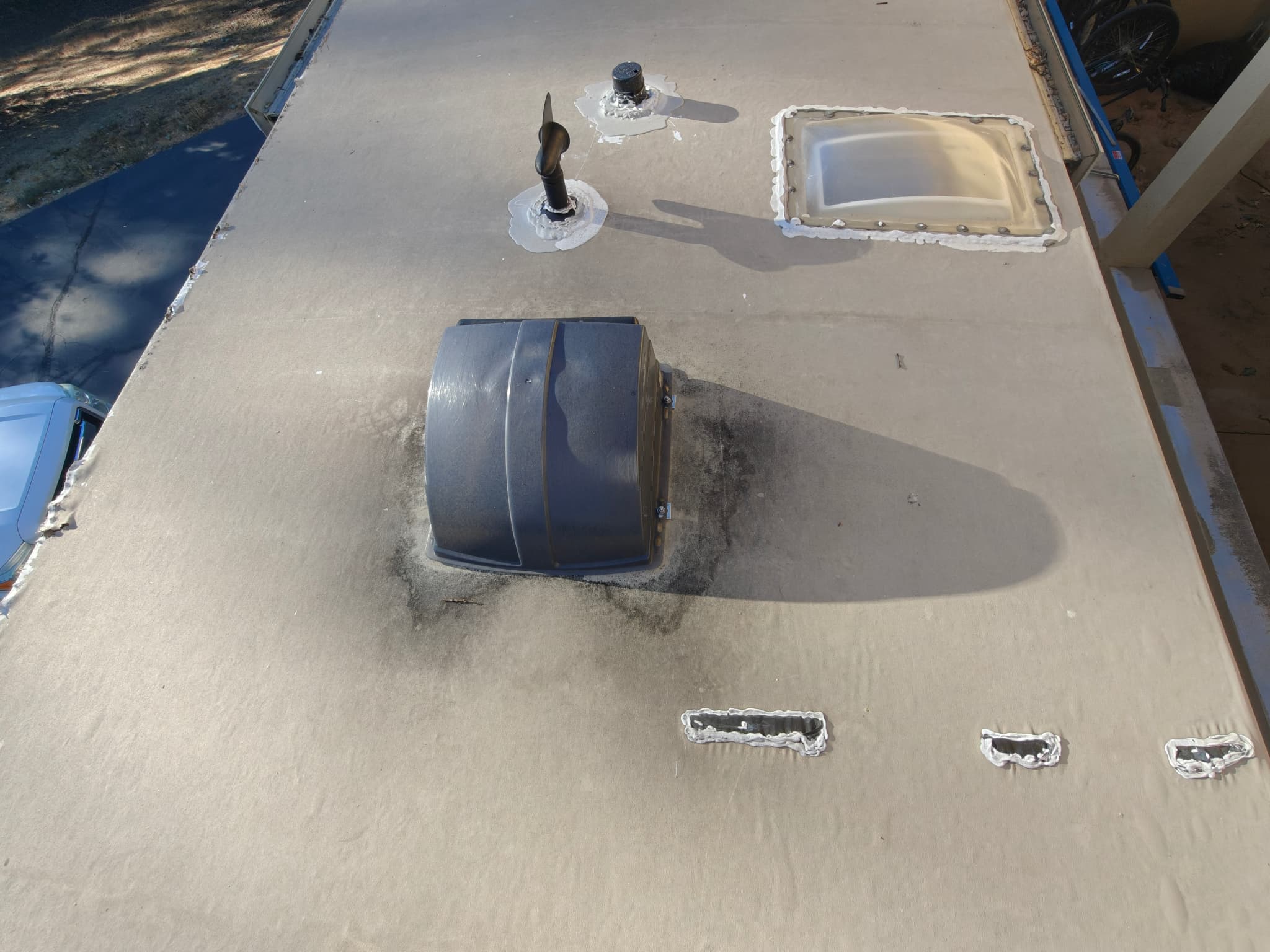 Dark damaged membrane near roof vent