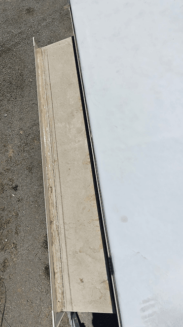 Damaged slide-out sealant before repair